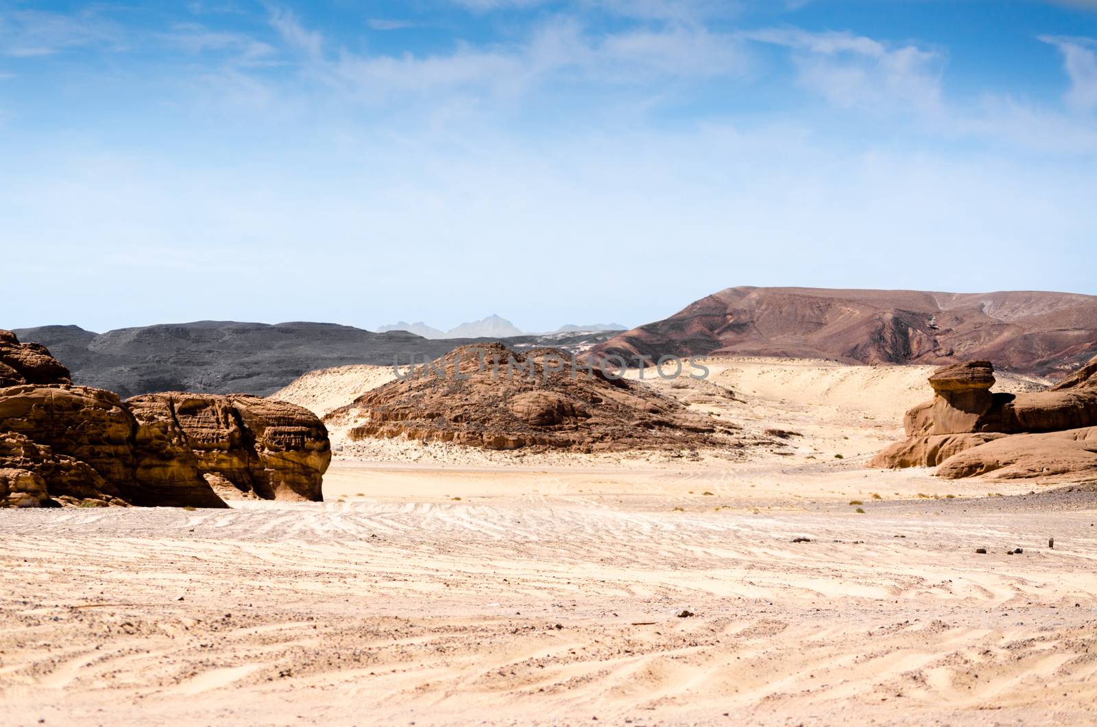 high rocky mountains against the blue sky and white clouds in the desert in Egypt Dahab South Sinai