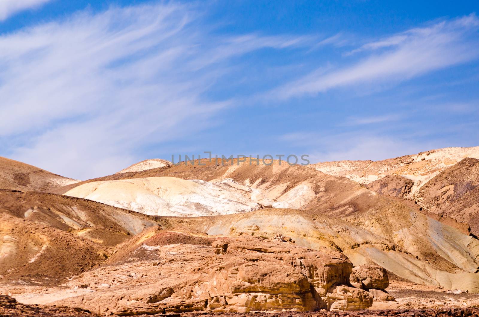 high rocky mountains against the blue sky and white clouds in the desert in Egypt Dahab South Sinai