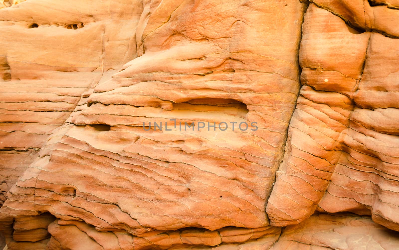 texture of orange stone rock in a colored canyon closeup