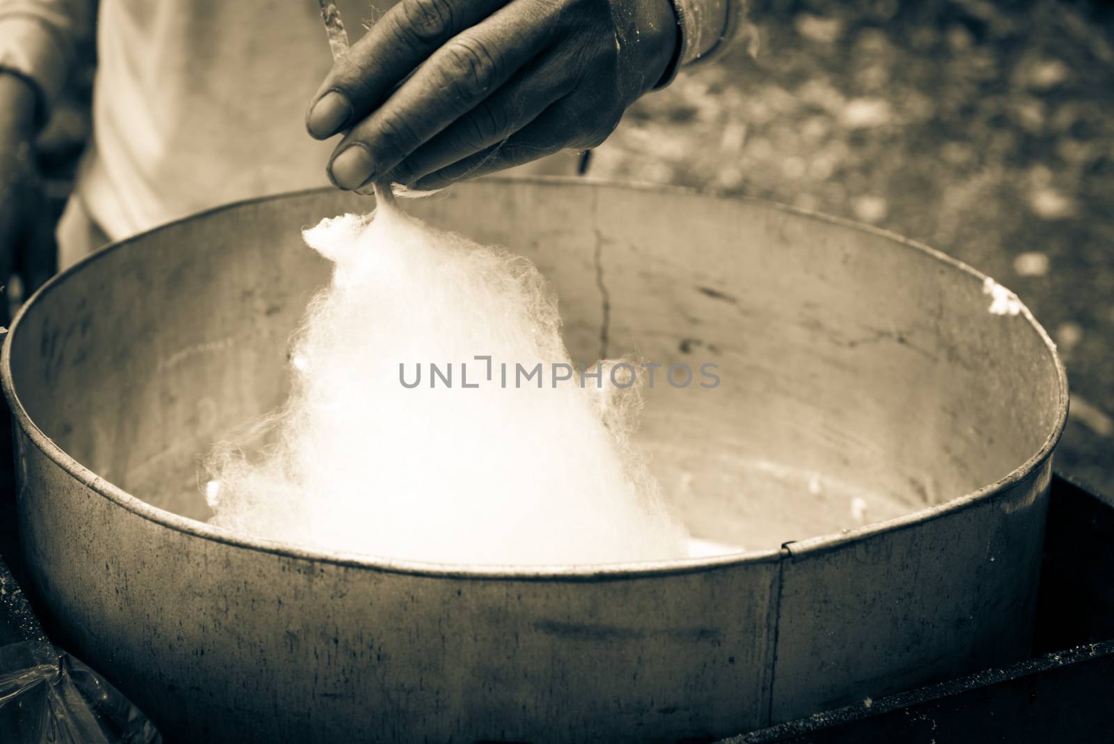 Finished puffy white cotton candy in floss machine in Vietnam. Process of street food making