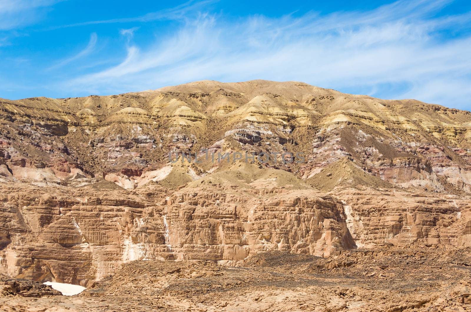 high rocky mountains in the desert against the blue sky and white clouds in Egypt Dahab
