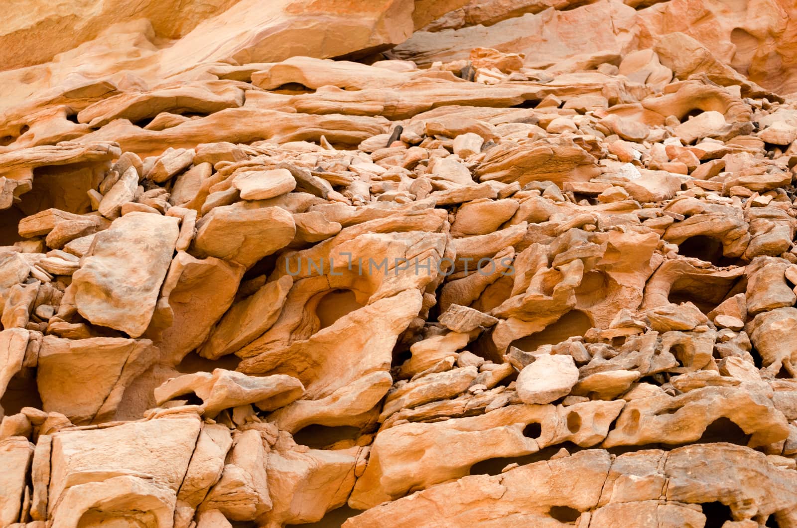 texture of orange stone rock in a colored canyon closeup