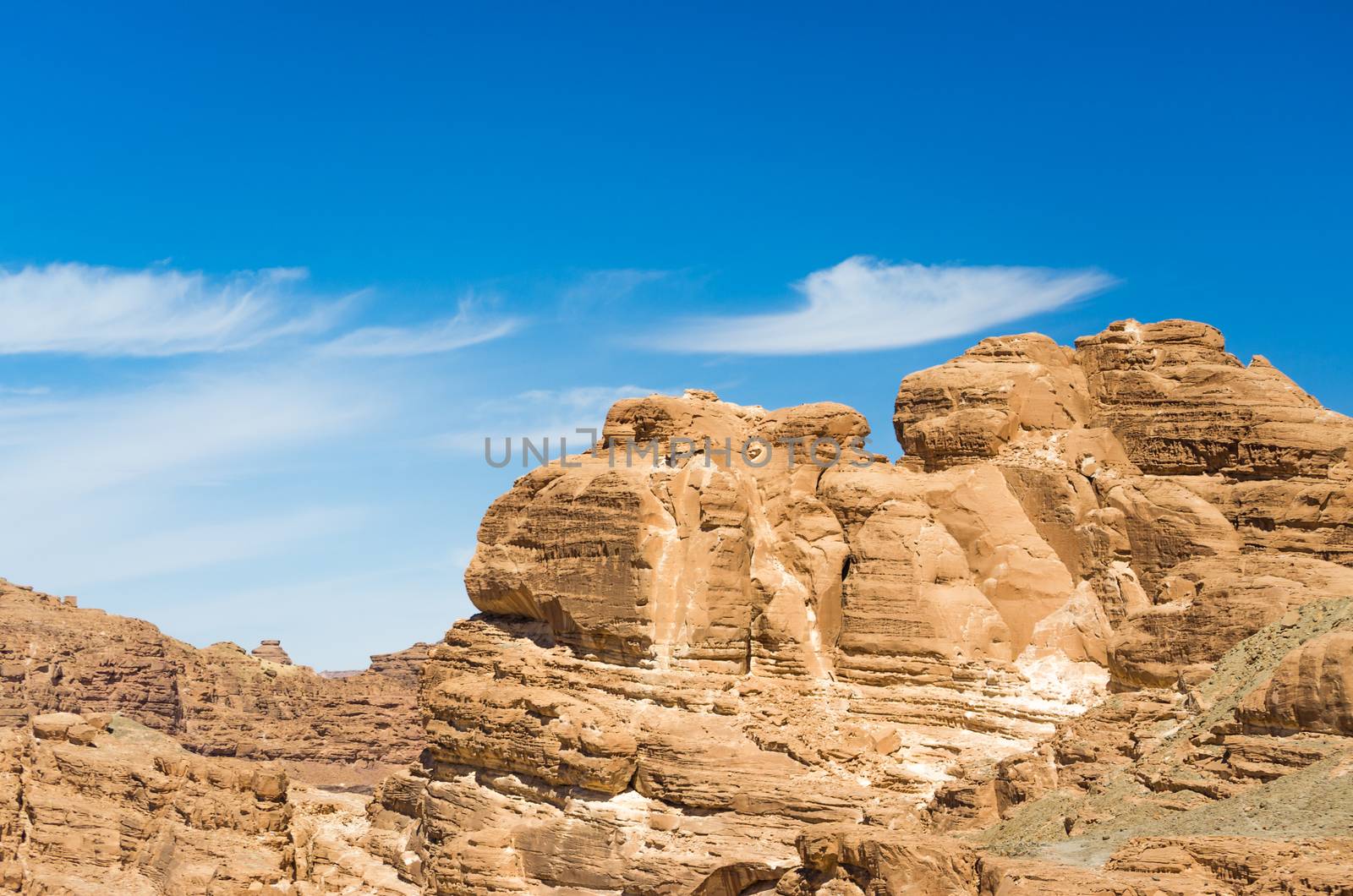 high rocky mountains in the desert against the blue sky and white clouds in Egypt Dahab