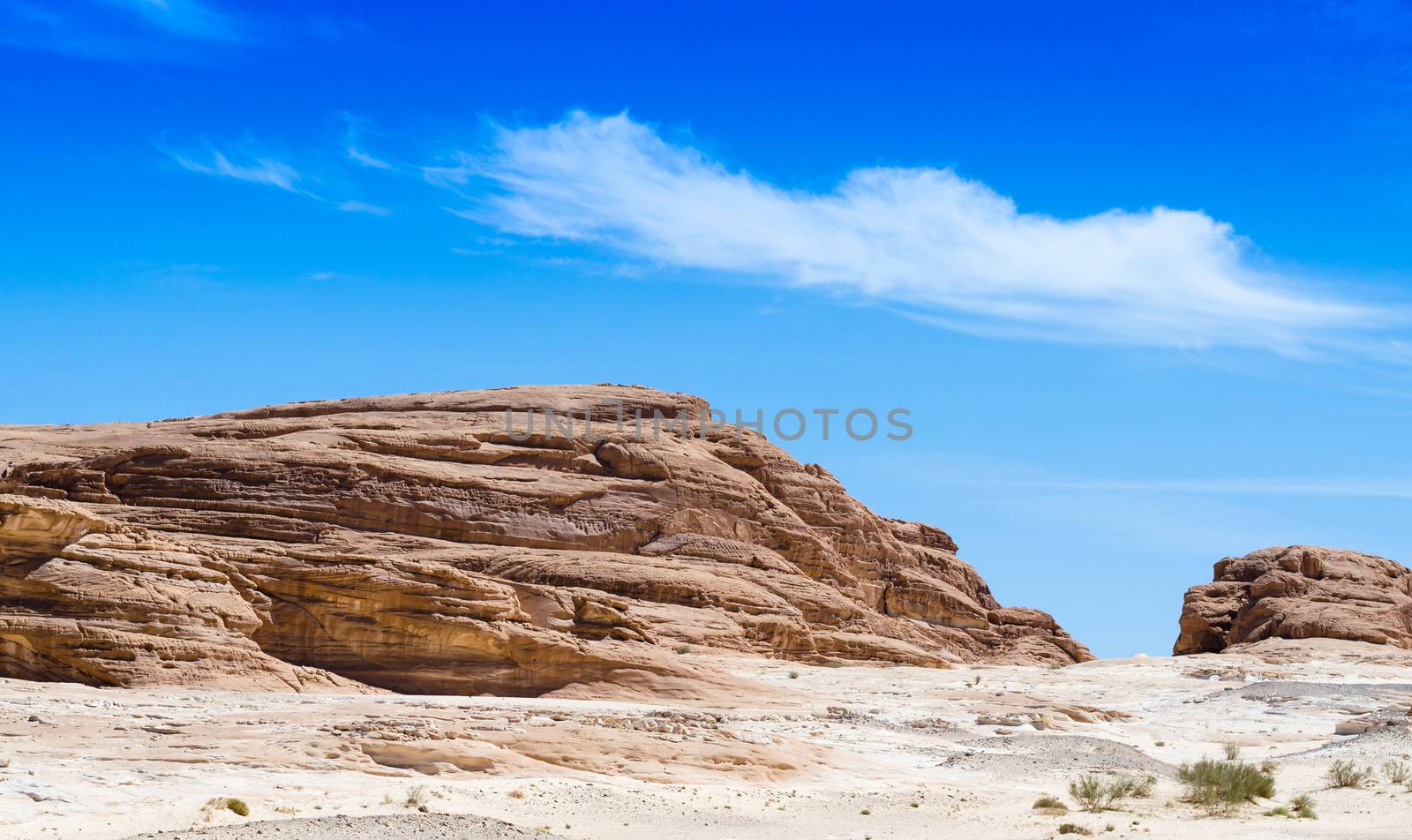 high rocky mountains against the blue sky and white clouds in the desert in Egypt Dahab South Sinai