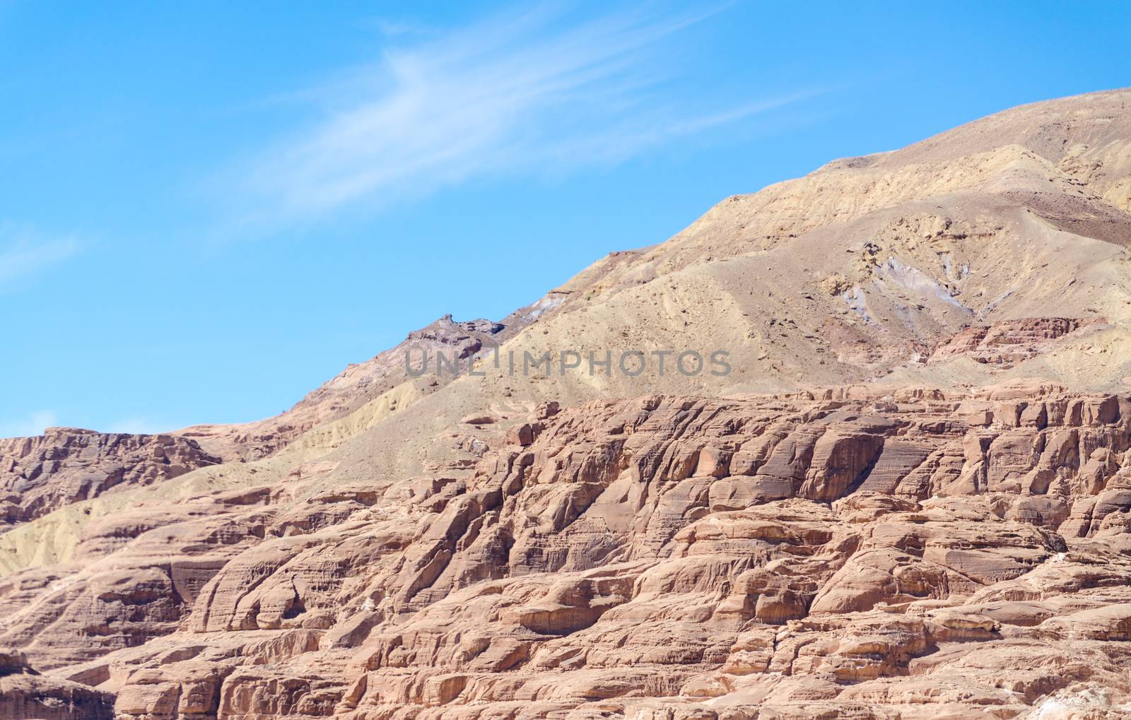 high rocky mountains against the blue sky and white clouds in the desert in Egypt Dahab South Sinai