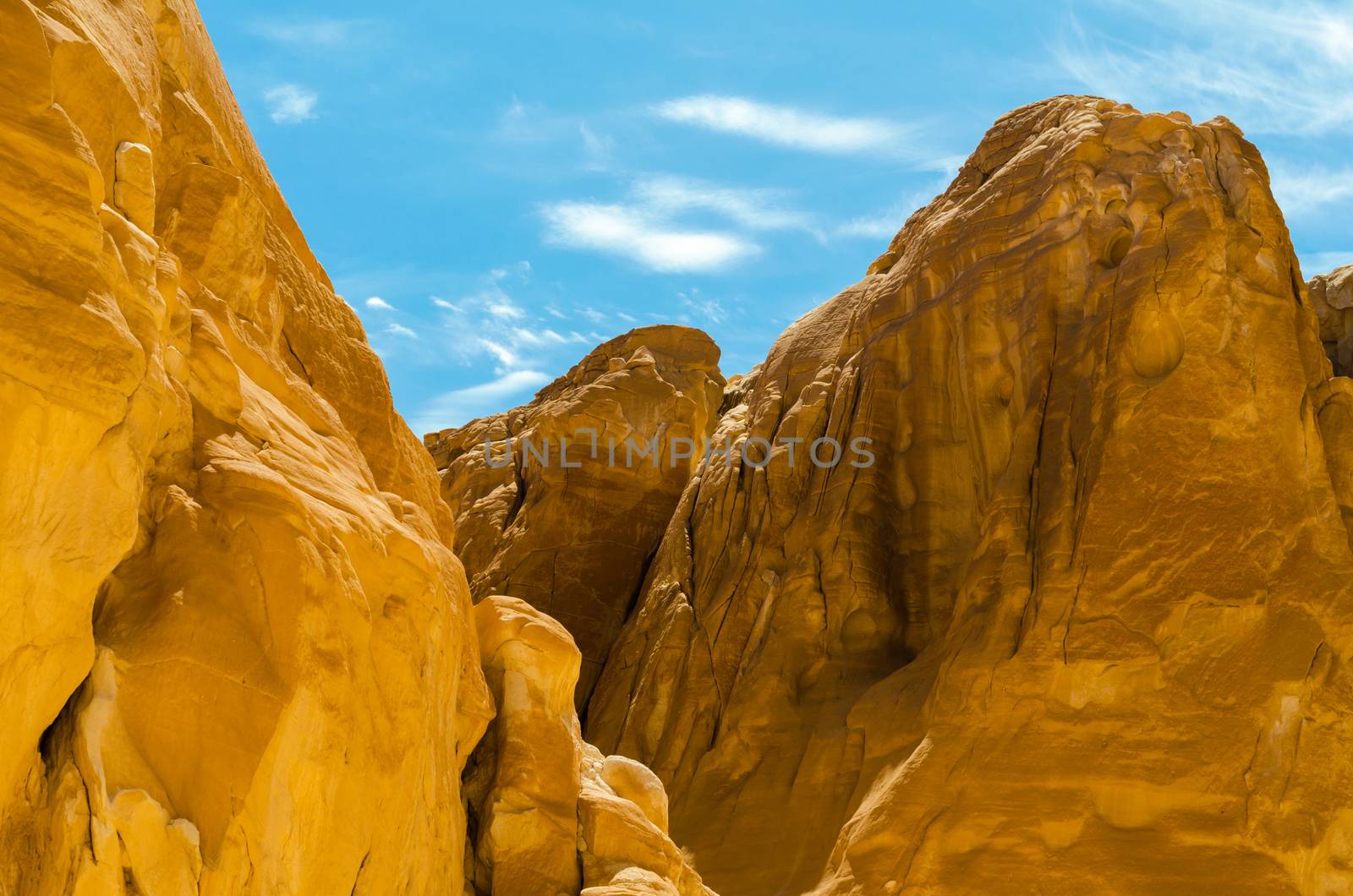 high rocky mountains against the blue sky and white clouds in the desert in Egypt Dahab South Sinai