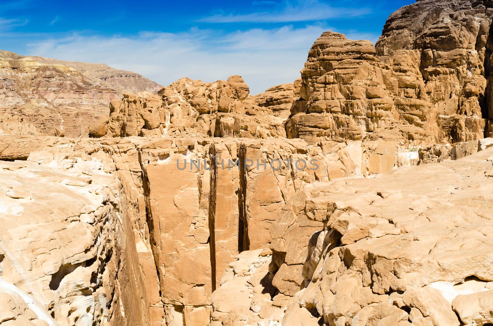 high rocky mountains against the blue sky and white clouds in the desert in Egypt Dahab South Sinai