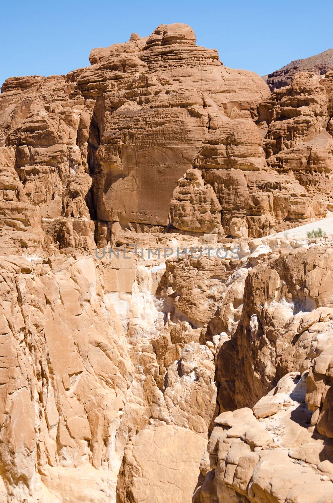 high rocky mountains against the blue sky and white clouds in the desert in Egypt Dahab South Sinai