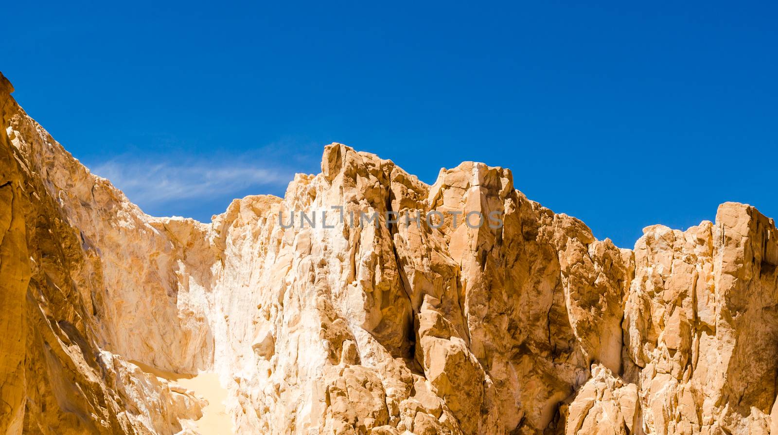 high rocky mountains against the blue sky and white clouds in the desert in Egypt Dahab South Sinai