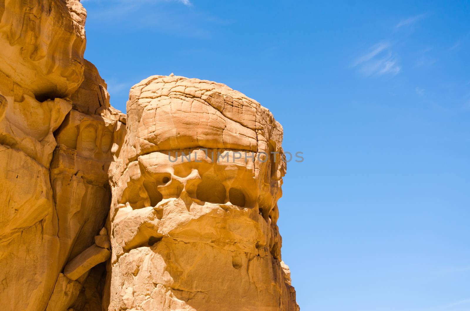high rocky mountains against the blue sky and white clouds in the desert in Egypt Dahab