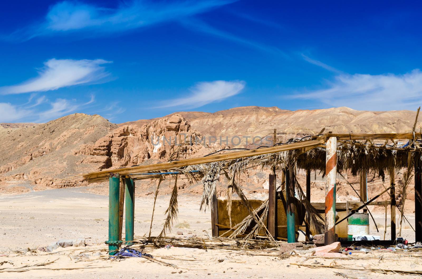 ruins in the desert against the backdrop of rocky mountains and blue sky with white clouds in Egypt
