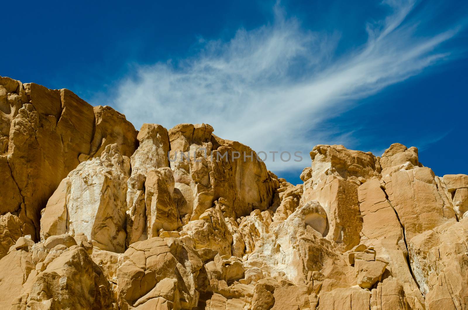 high rocky mountains against the blue sky and white clouds in the desert in Egypt Dahab South Sinai