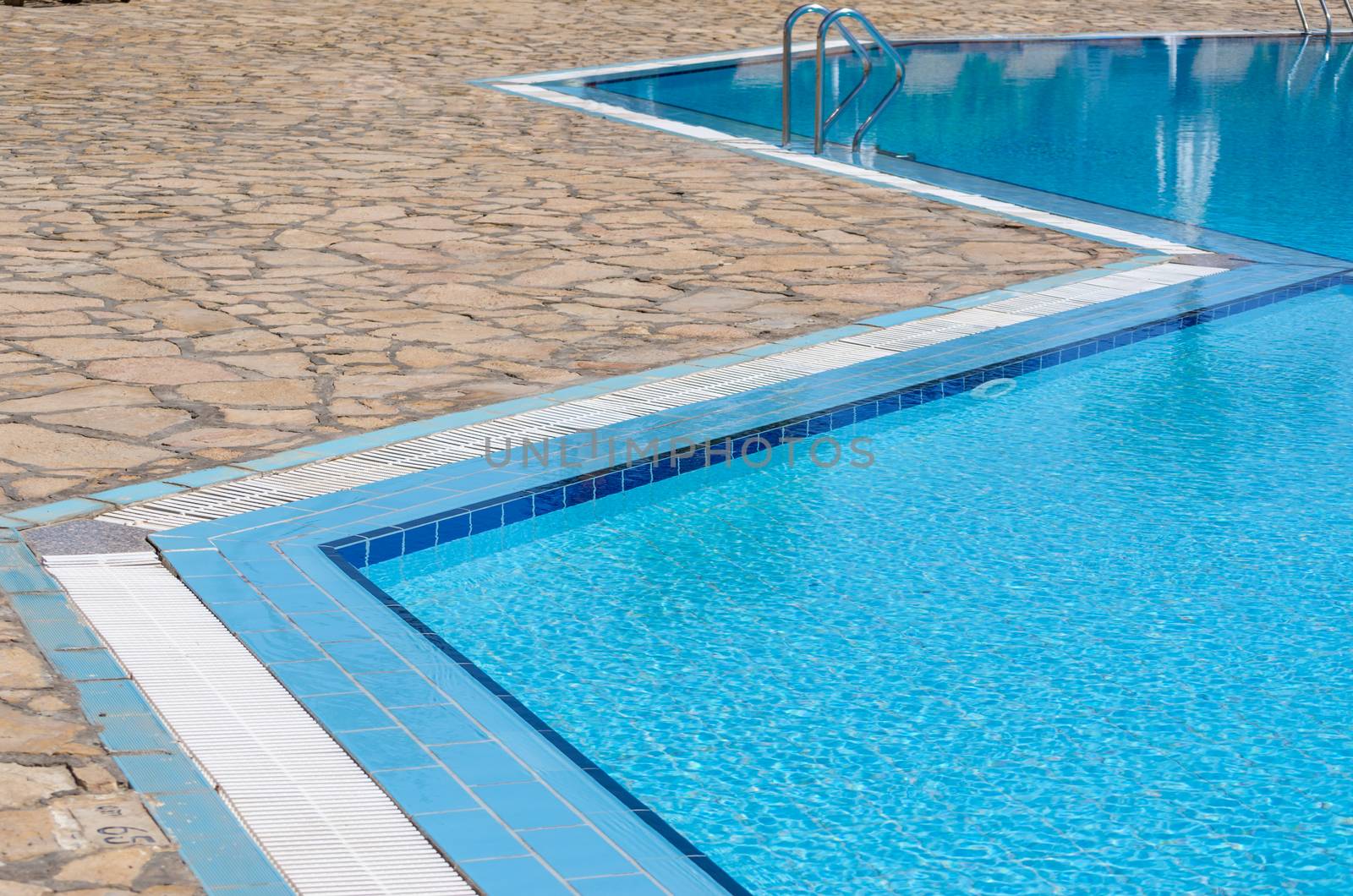 swimming pool with blue water in the hotel