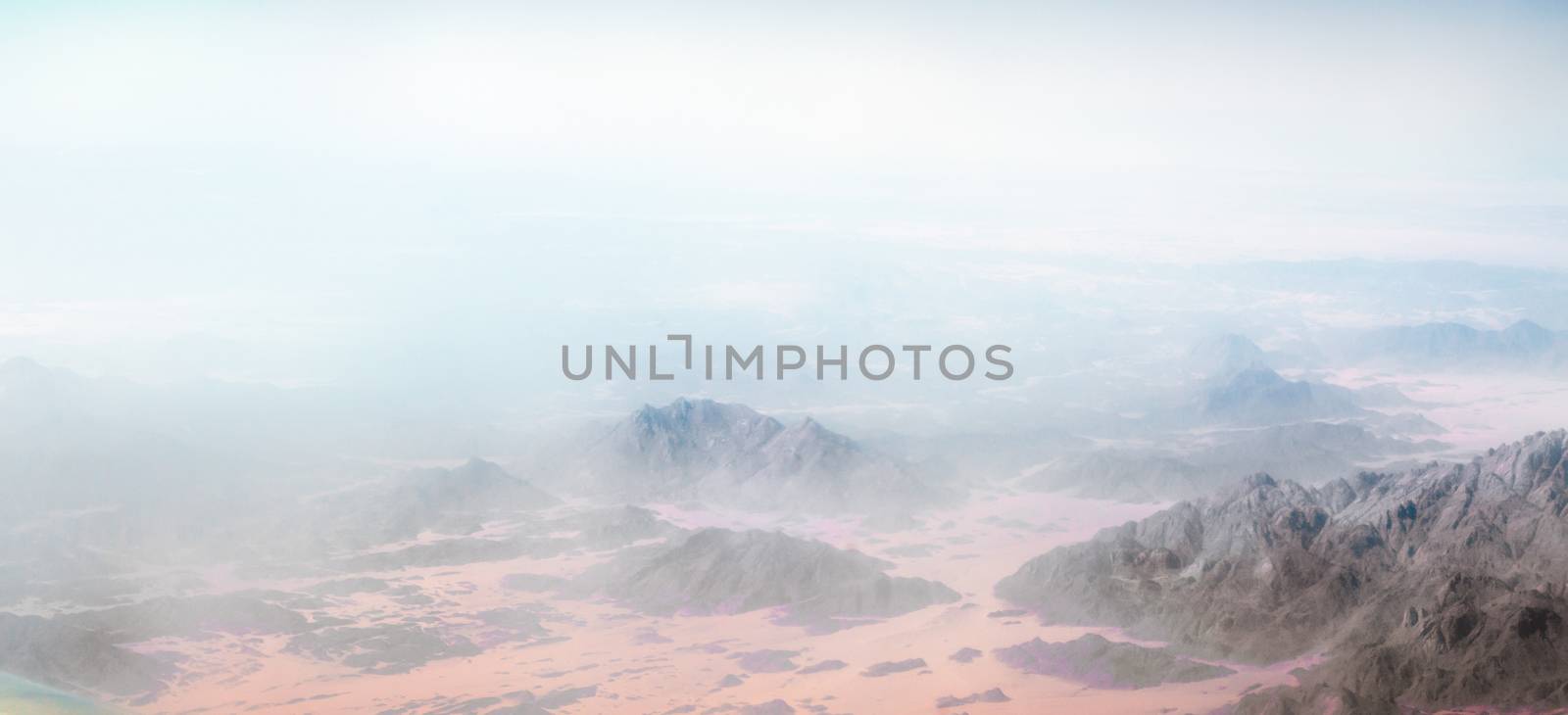 panorama from the airplane window to the mountains and desert in Egypt