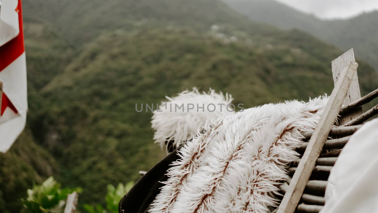 Georgian traditional clothes with mountains after it. Sky with clouds backwards