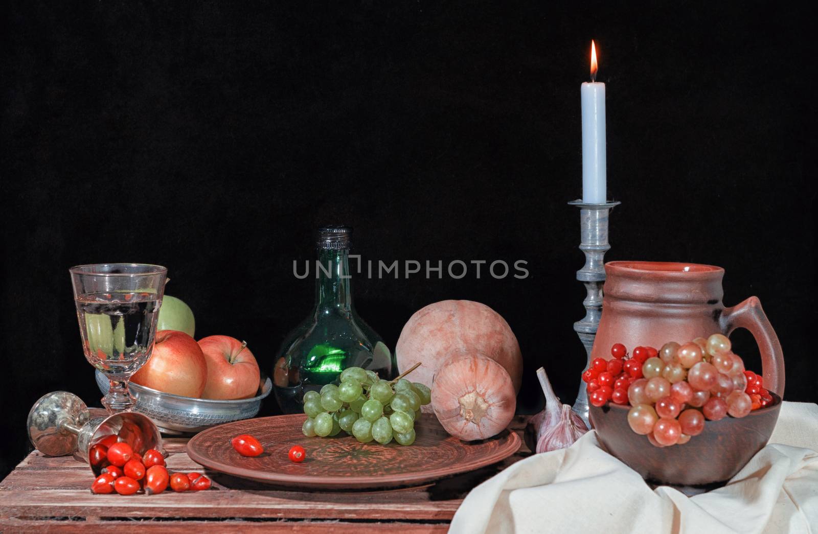 autumn still life with vegetables fruits and candle