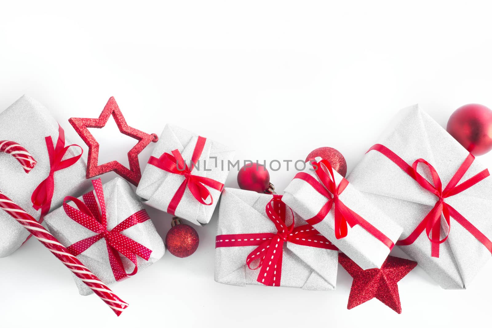 Border frame design element background of silver glitter gifts with red ribbon bow decoration stars baubles and candy cane isolated on white background top view flat lay composition with copy space for text