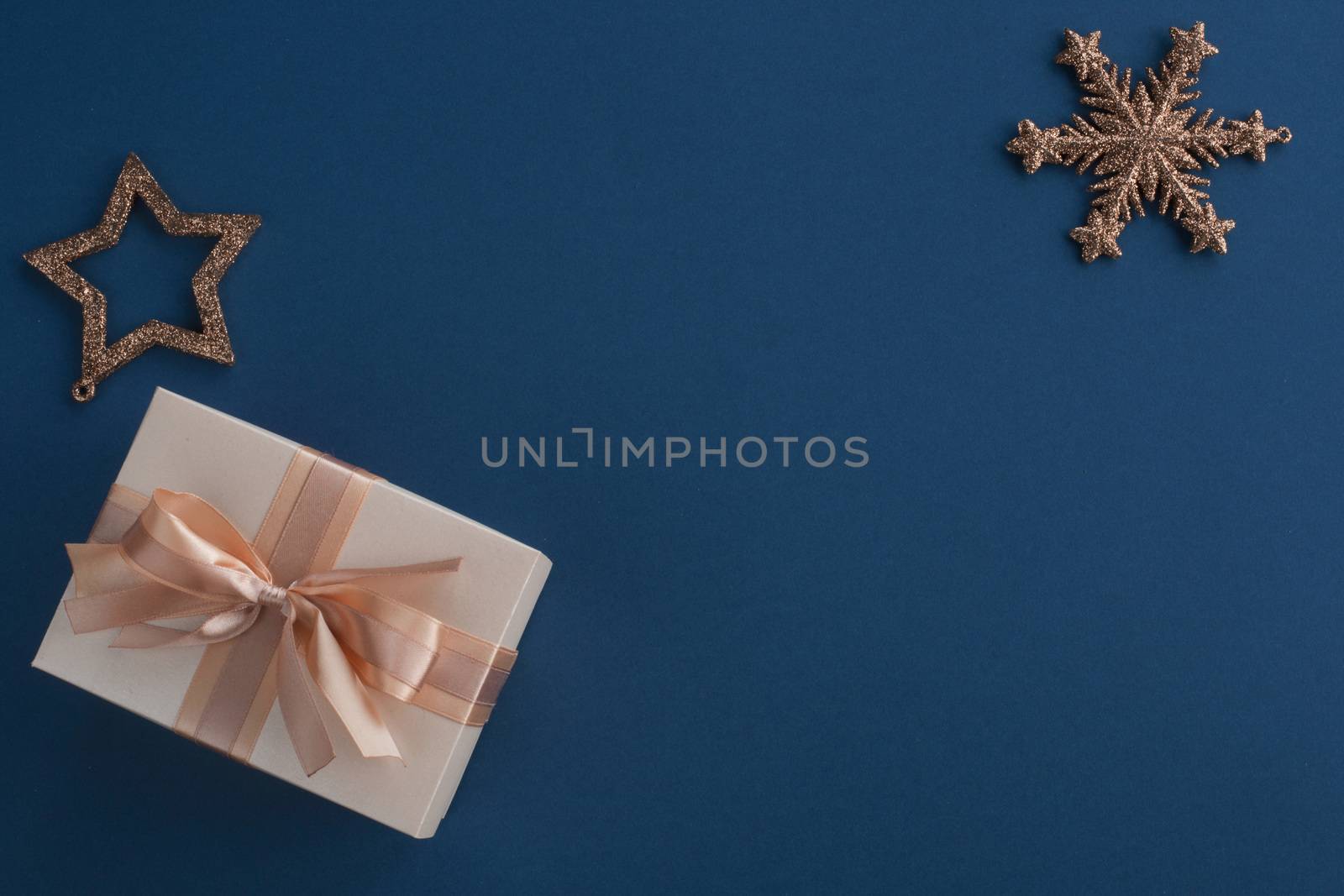 Unusual Christmas gift on stylish dark blue background with copy space for text , top view flat lay design composition