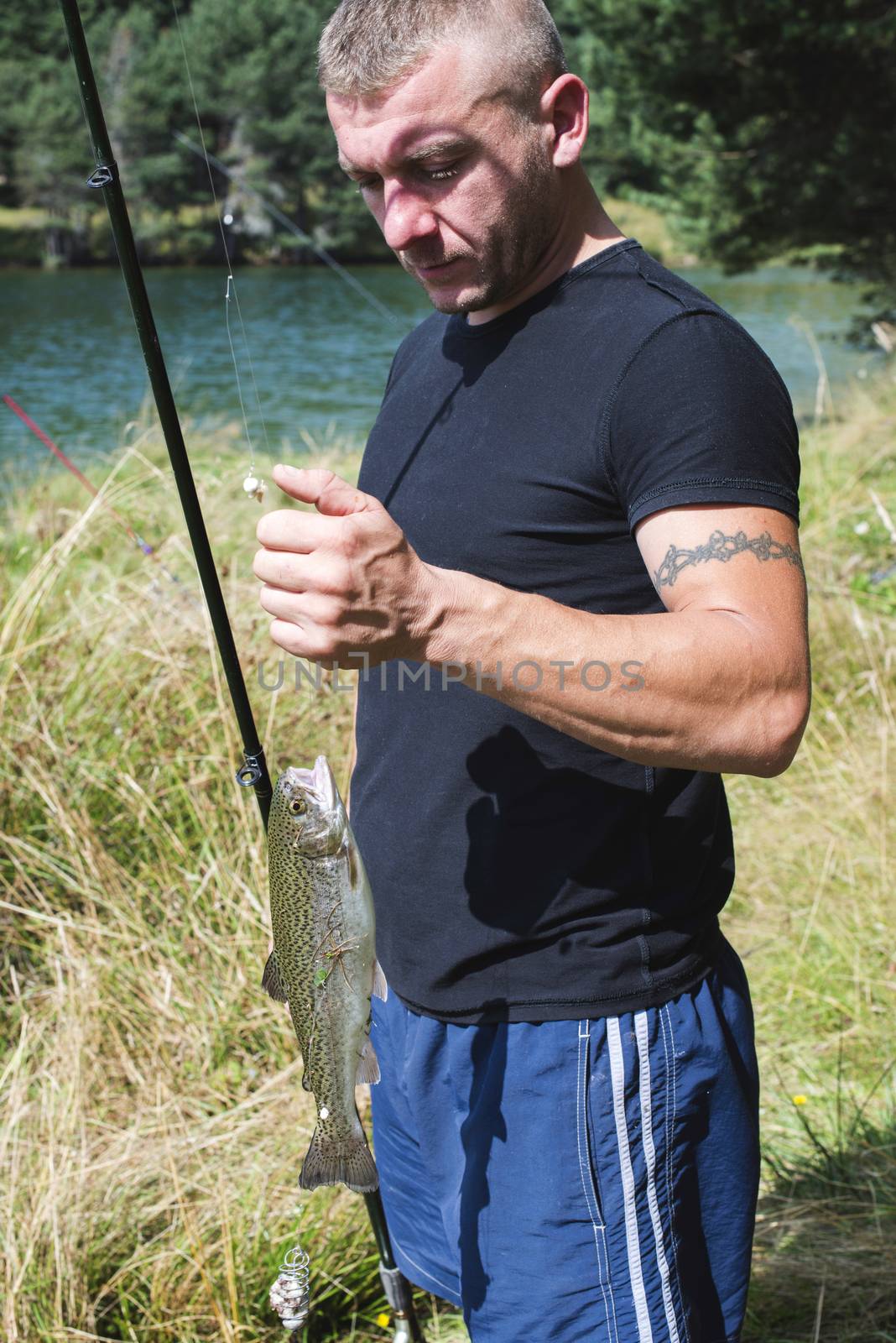 Fisherman caught a fish in mountain dam. Bulgaria