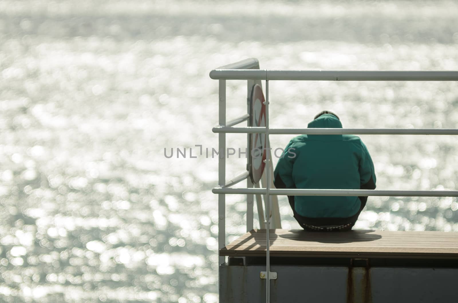 Man sitting in front of the sea in silence and thinking