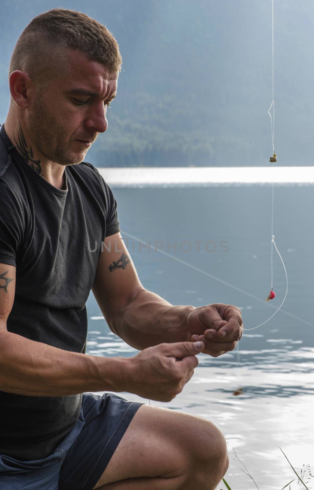 Man prepare rod for fishing by deyan_georgiev