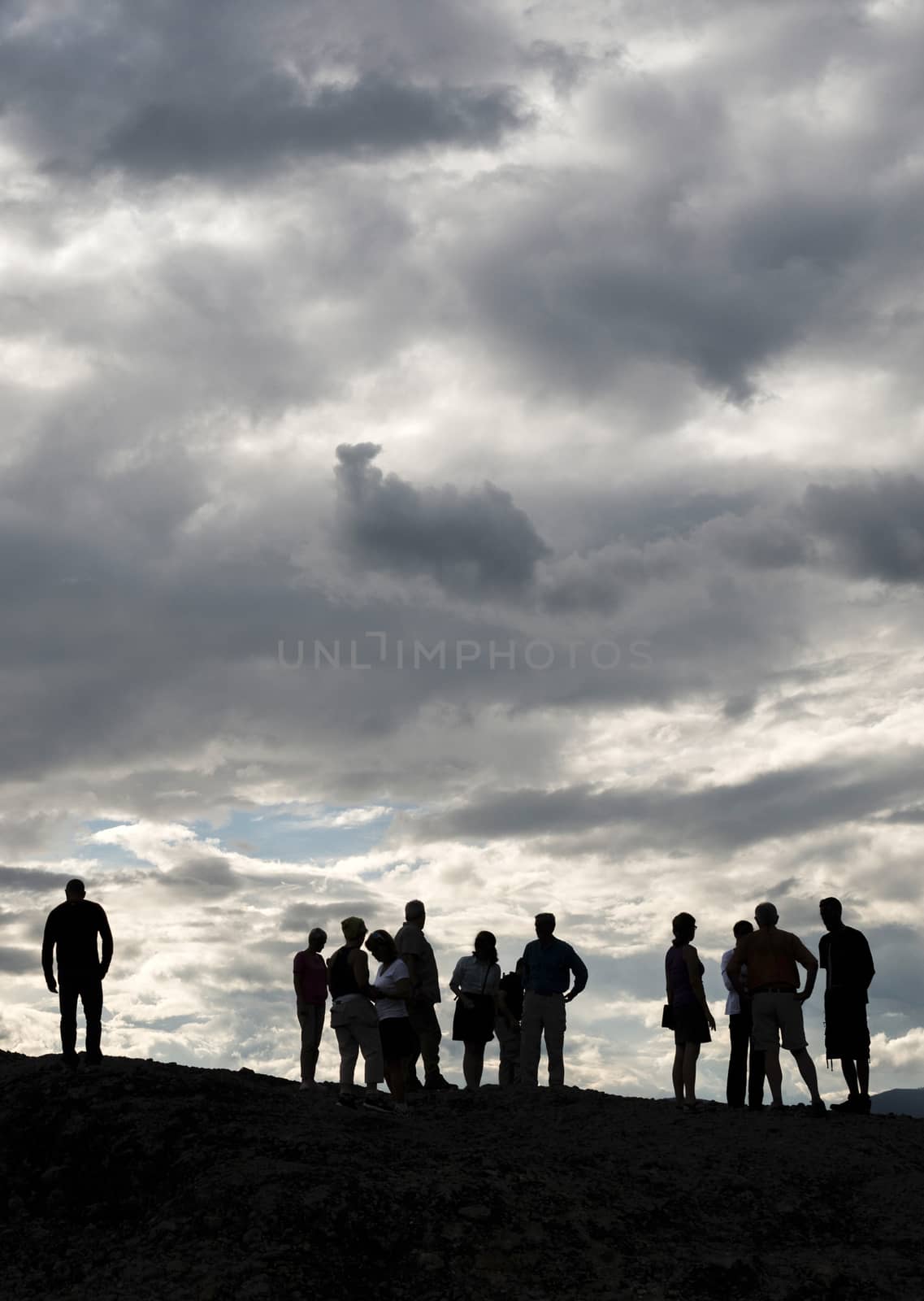People on the top of the rocks. Cloudy sky. Greece, Meteora