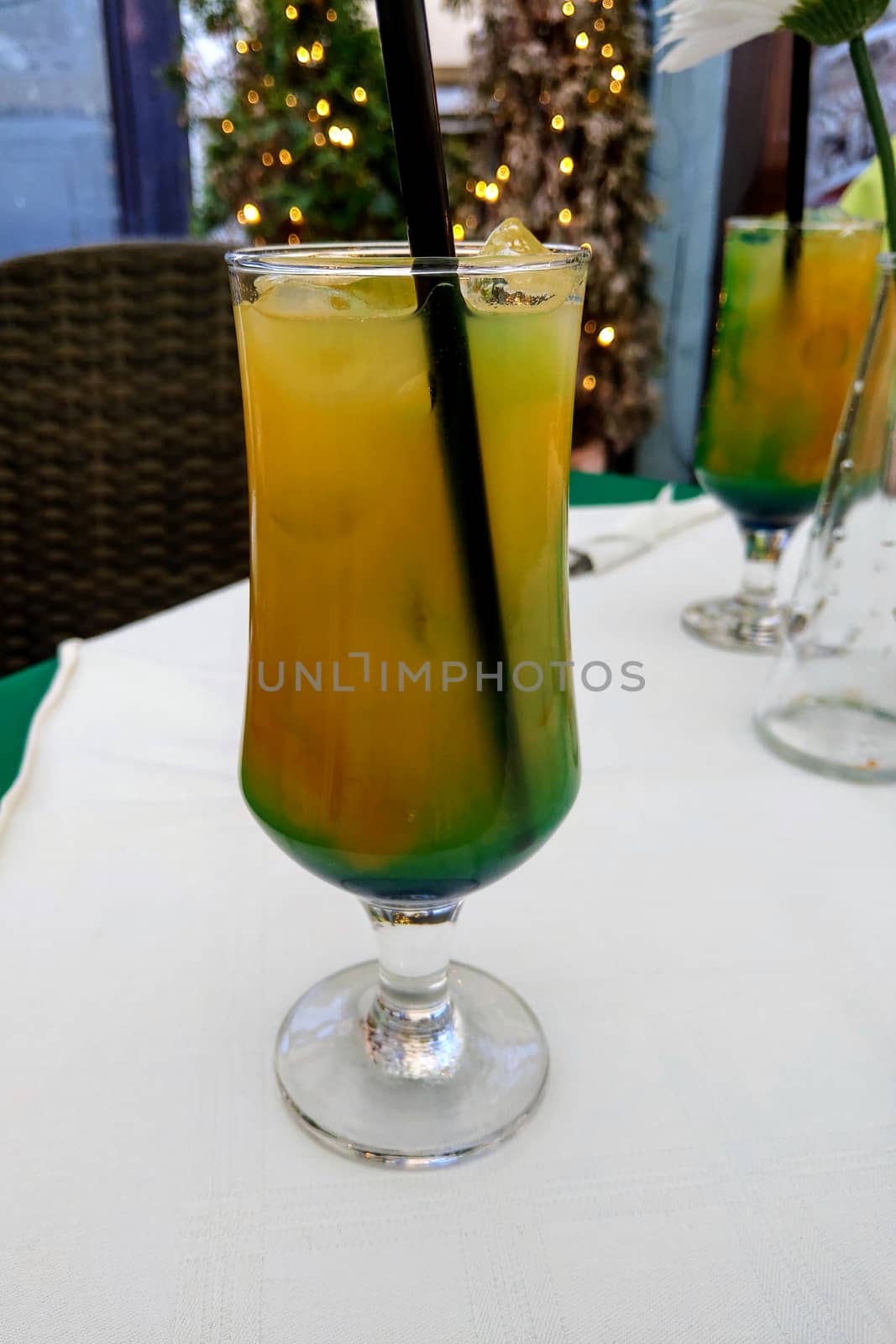 View of a cool glass of cocktail on a table on a hot day, freshness, coolness