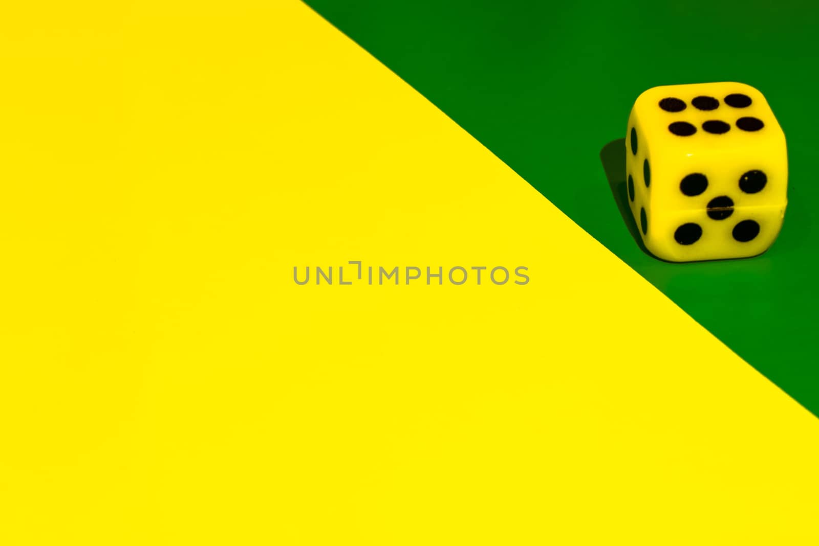 white and yellow dice on a combined green and yellow background