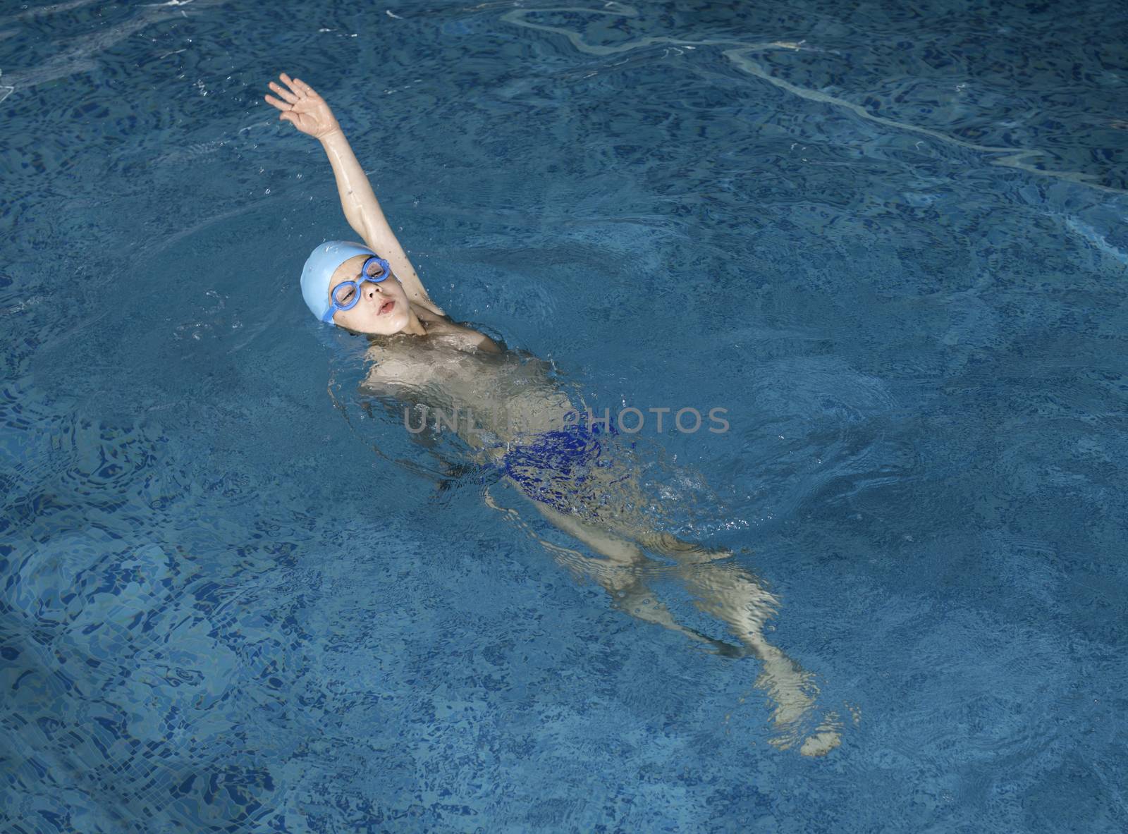 Child swimmer in swimming pool by deyan_georgiev