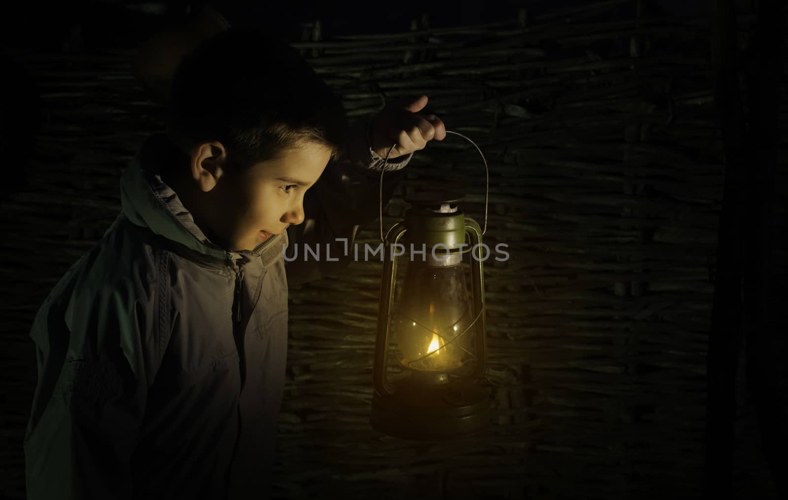 Child walk in the darkness with gas lantern