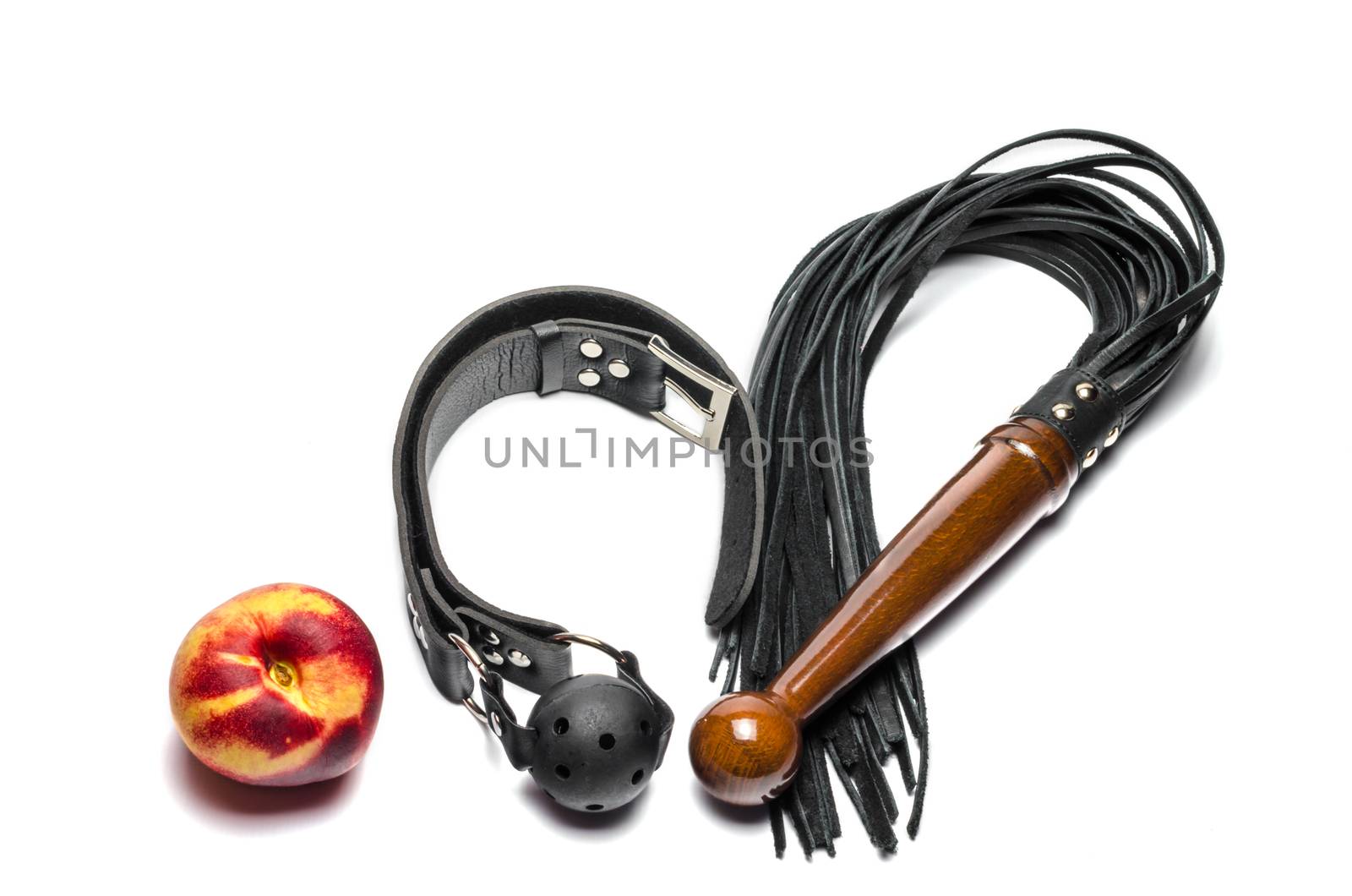bdsm leather black gag whip and ripe peach fruit on white background