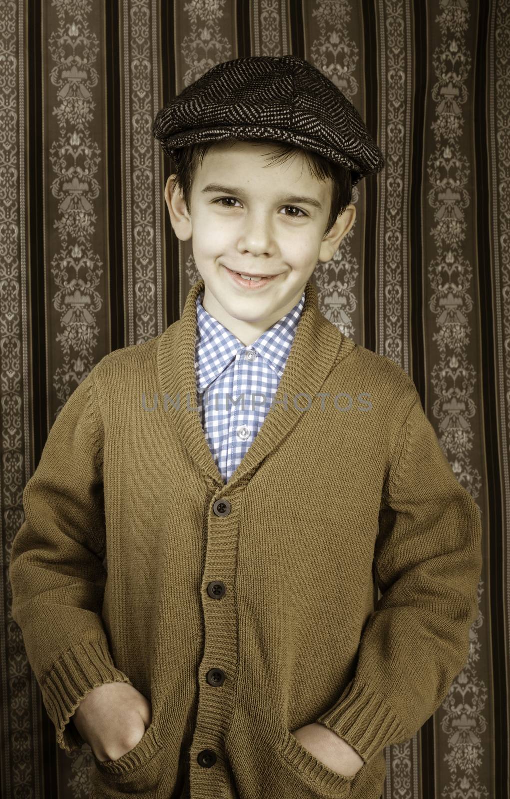 Smiling child in vintage clothes and hat. Close up shot