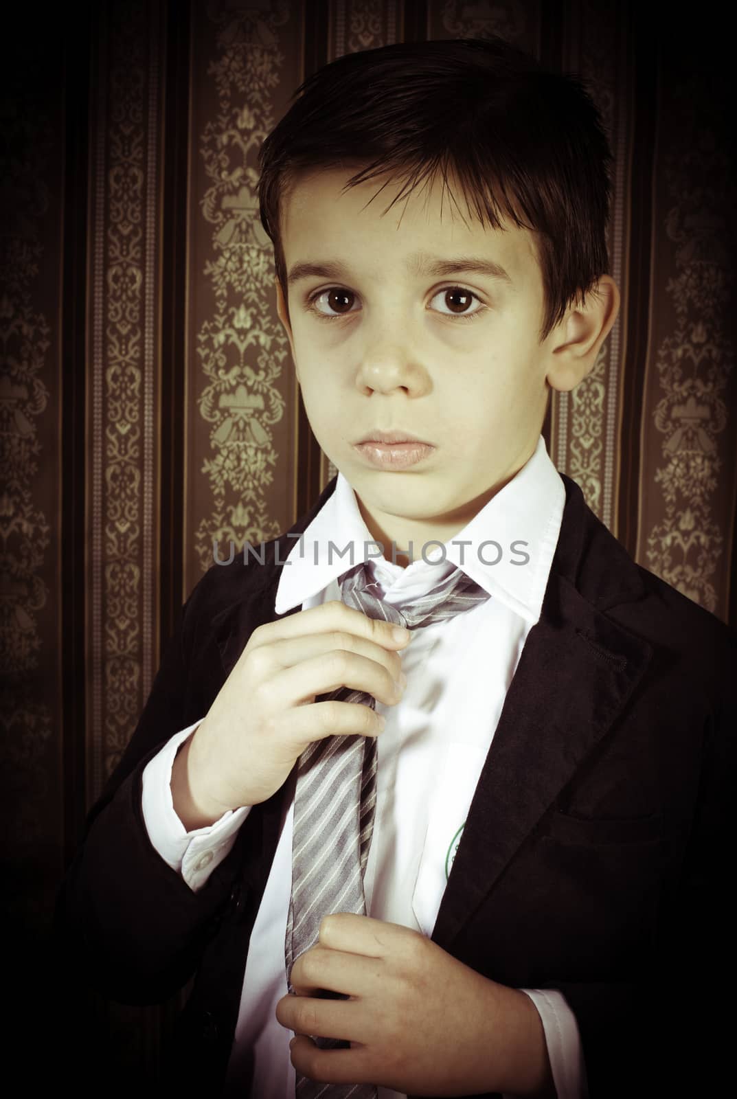 Boy in vintage black suit and tie
