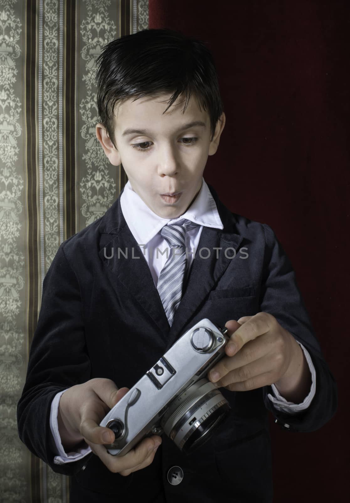 Child taking pictures with vintage camera by deyan_georgiev