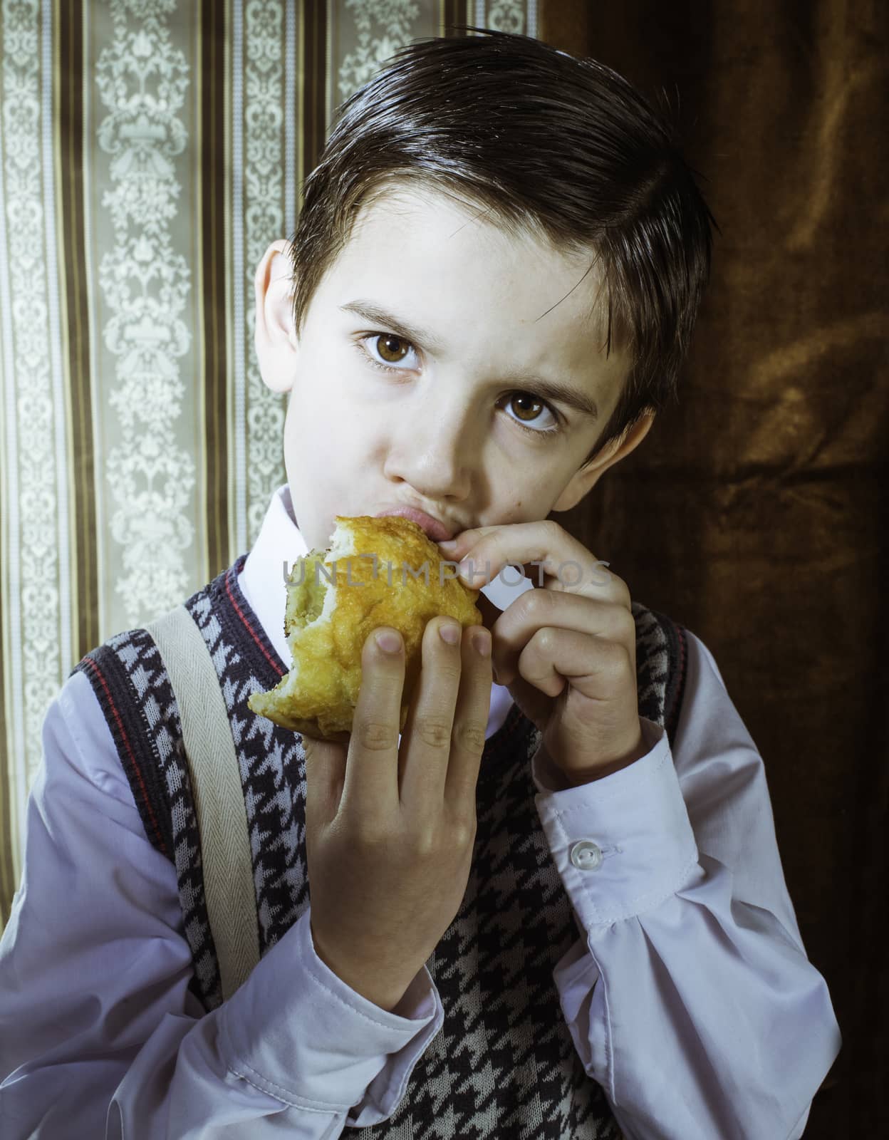 Child who eat donut. Vintage clothes and background