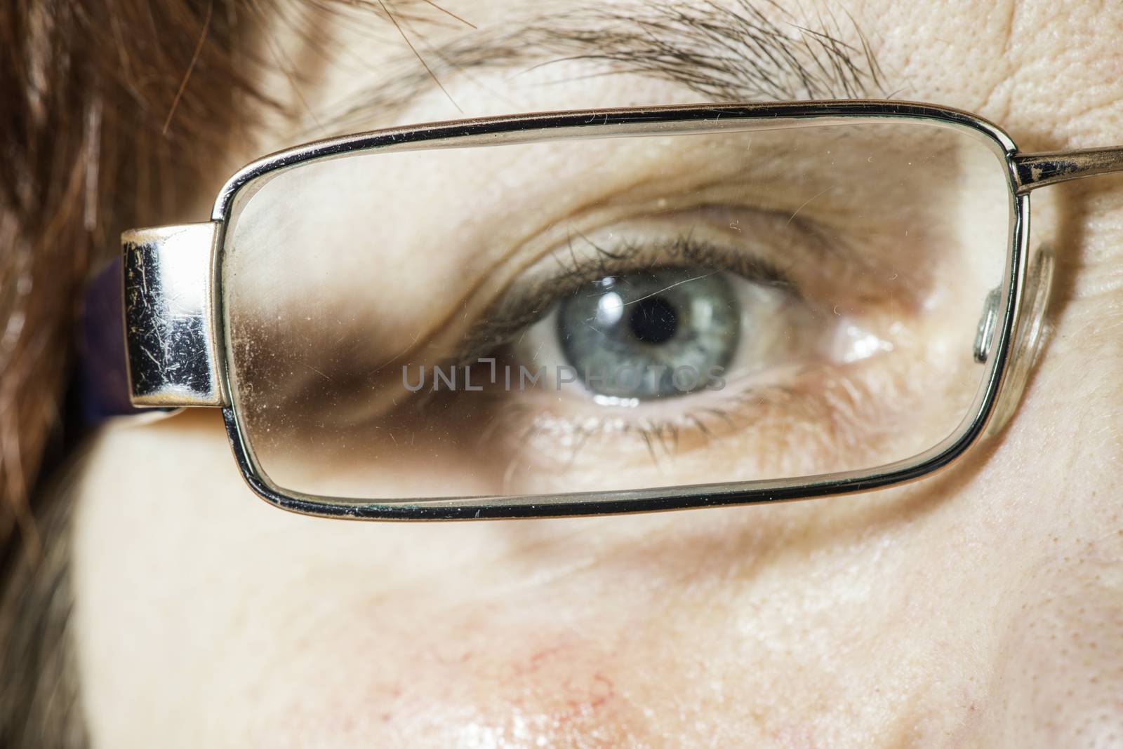 Close up old women blue eye and glasses