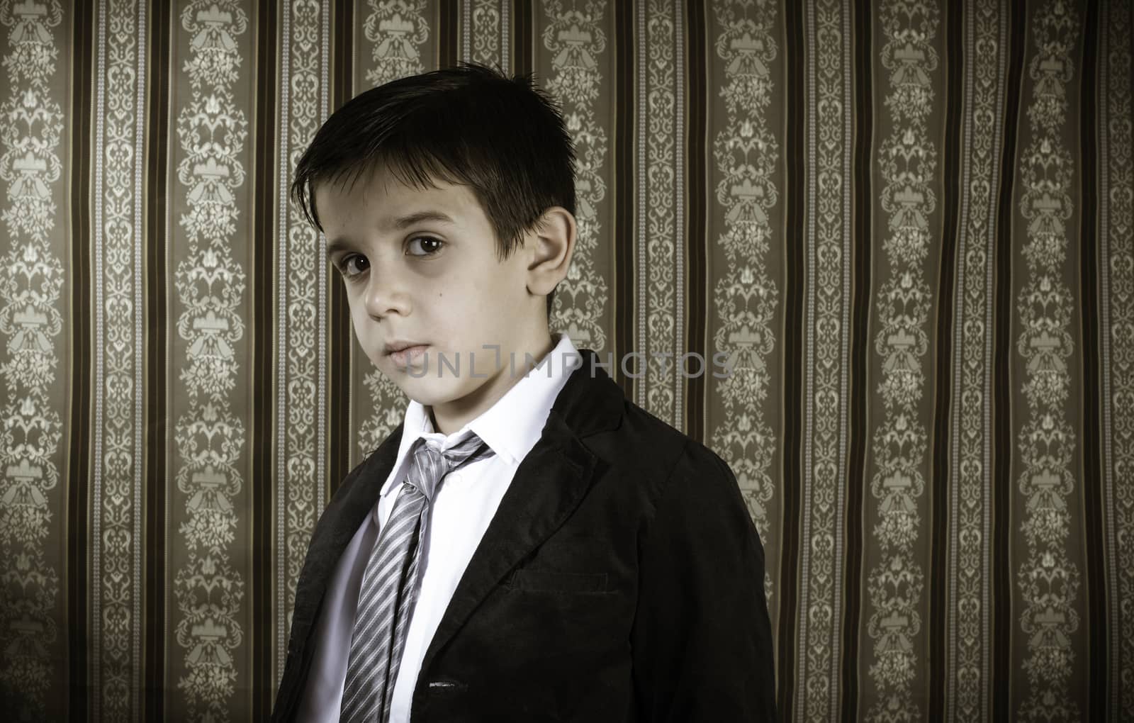 Boy in vintage black suit and tie