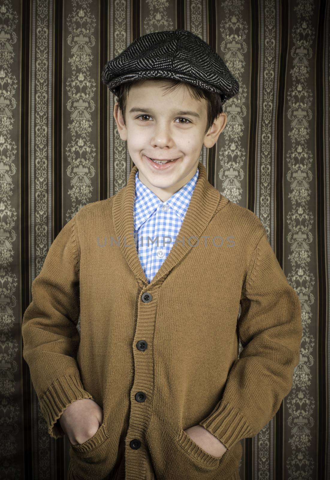 Smiling child in vintage clothes and hat. Close up shot