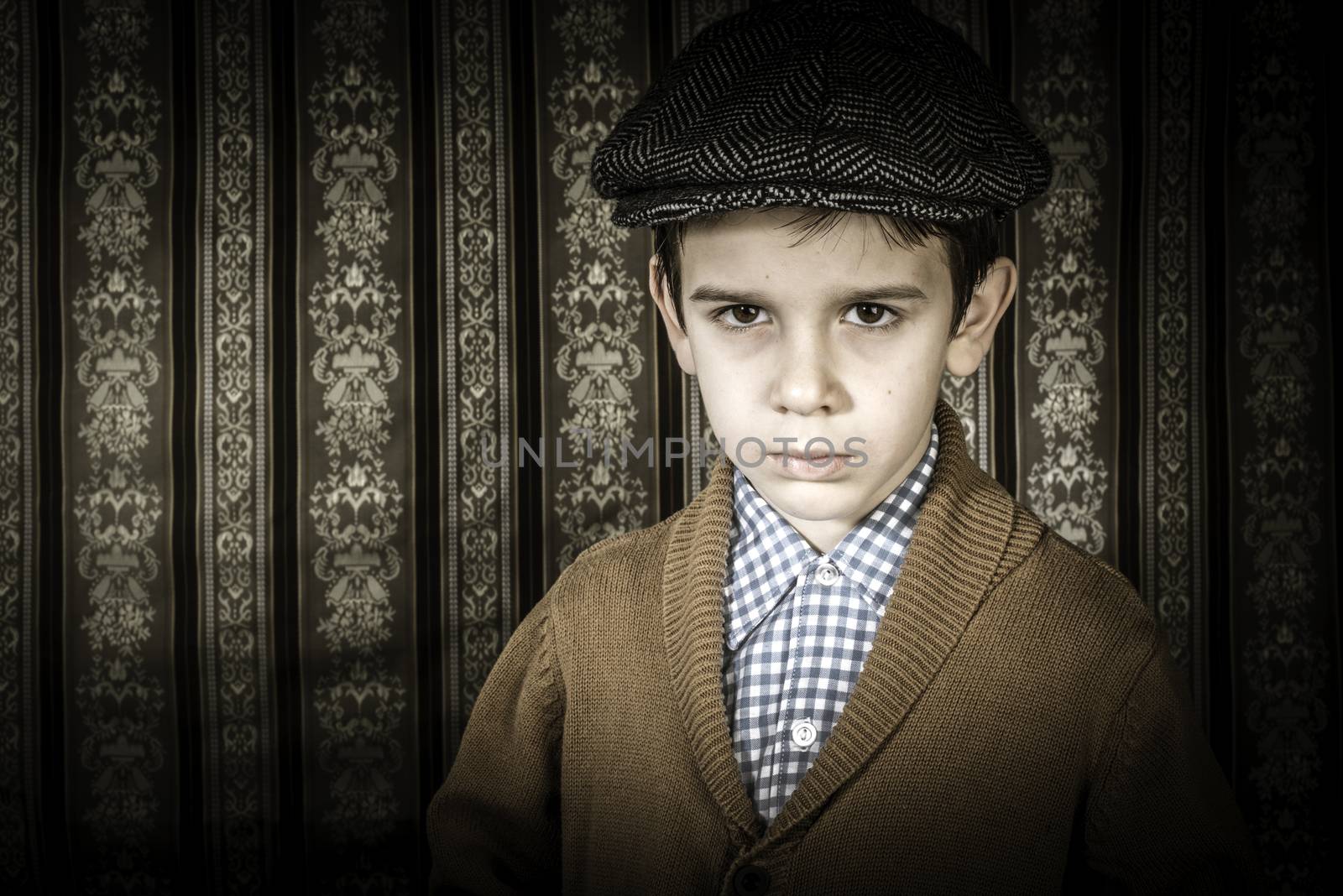 Frowning child in vintage clothes and hat by deyan_georgiev