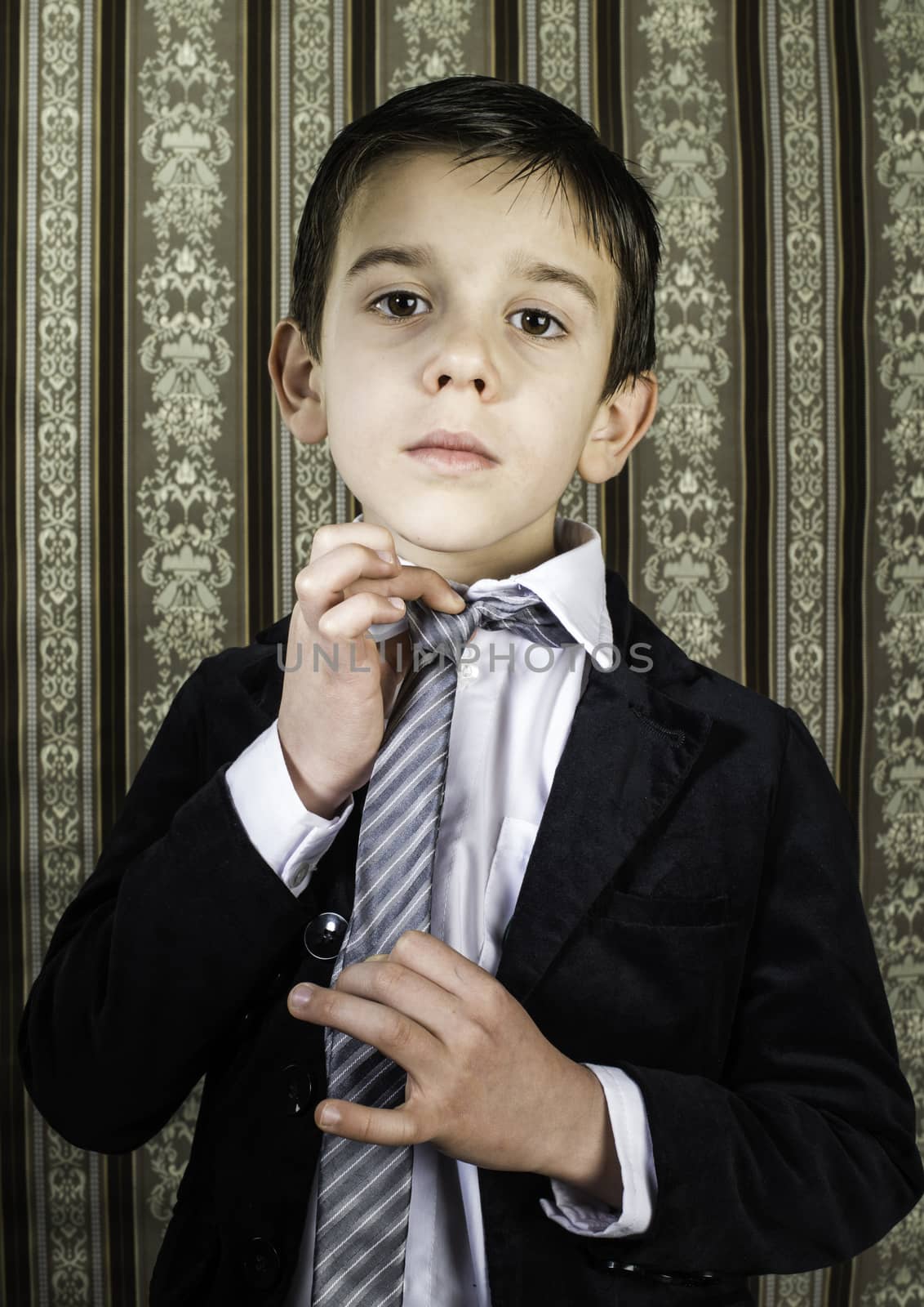 Boy in vintage black suit and tie