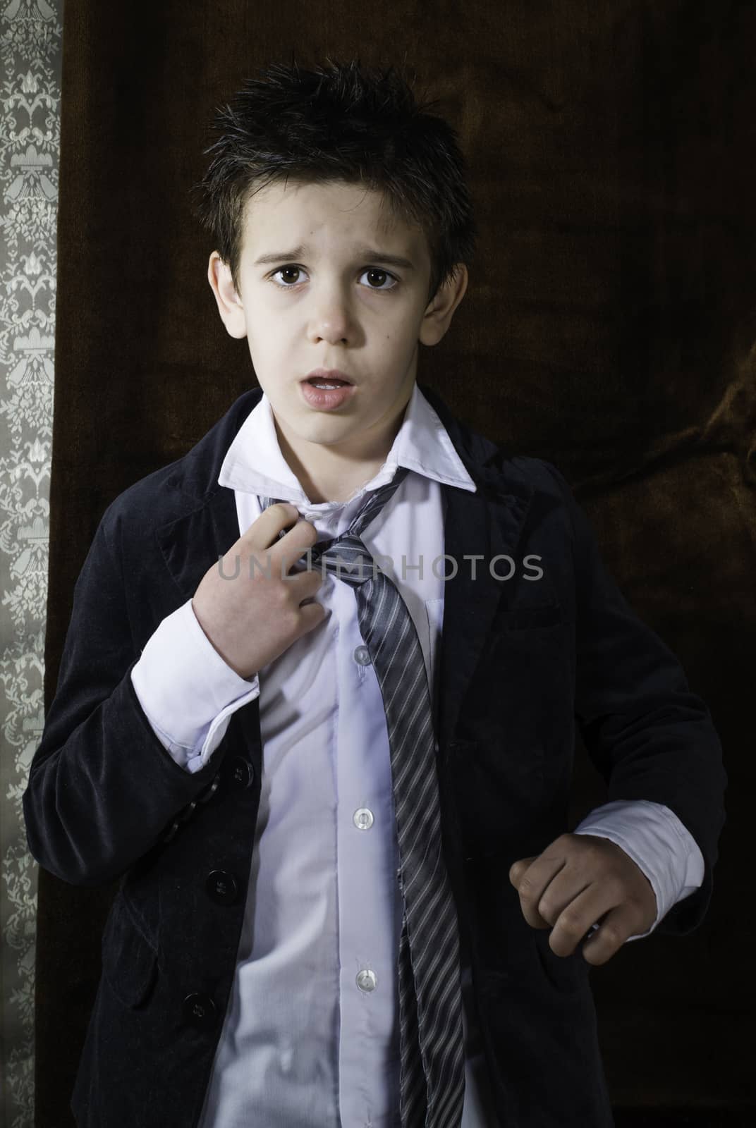 Boy in vintage black suit and tie