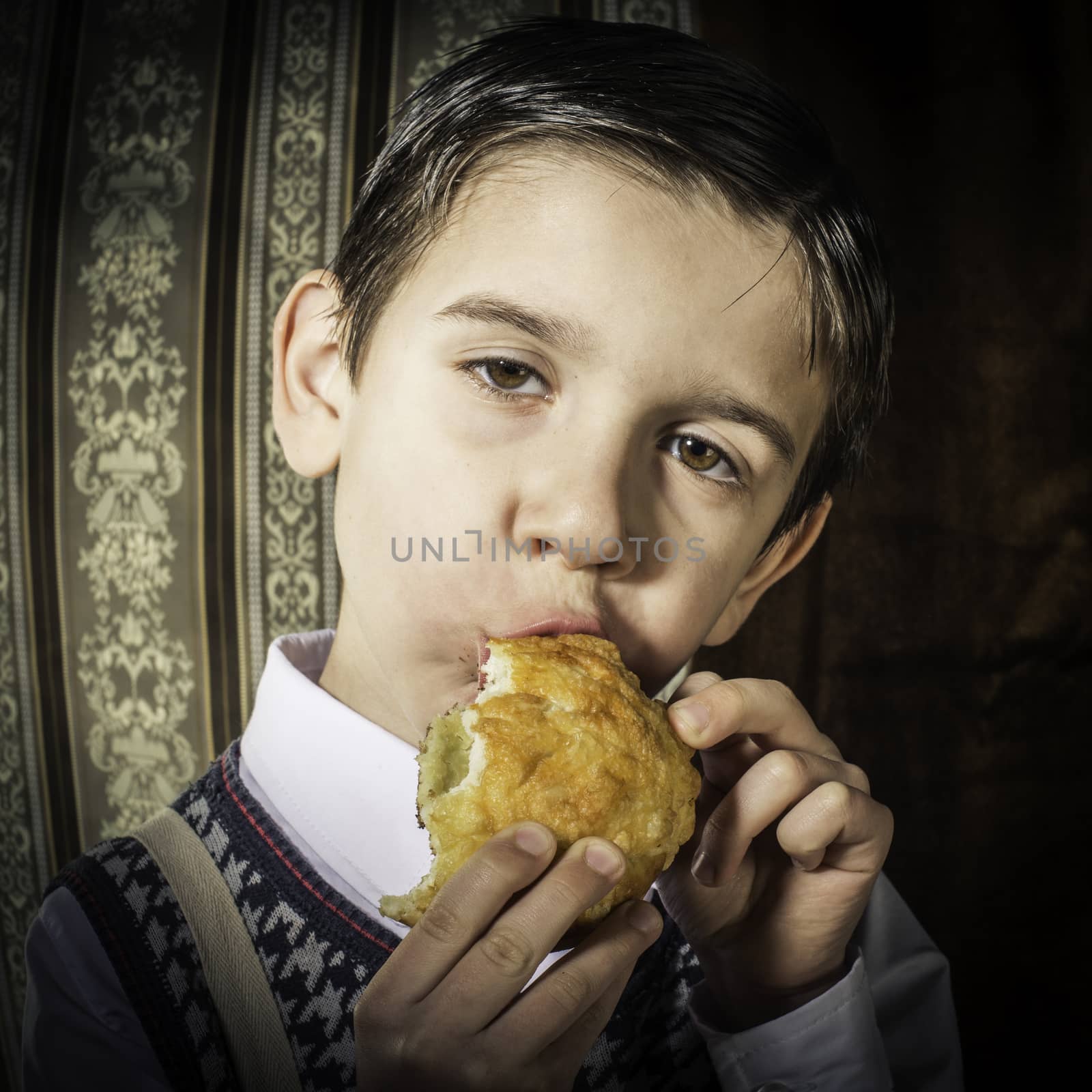 Child who eat donut. Vintage clothes and background