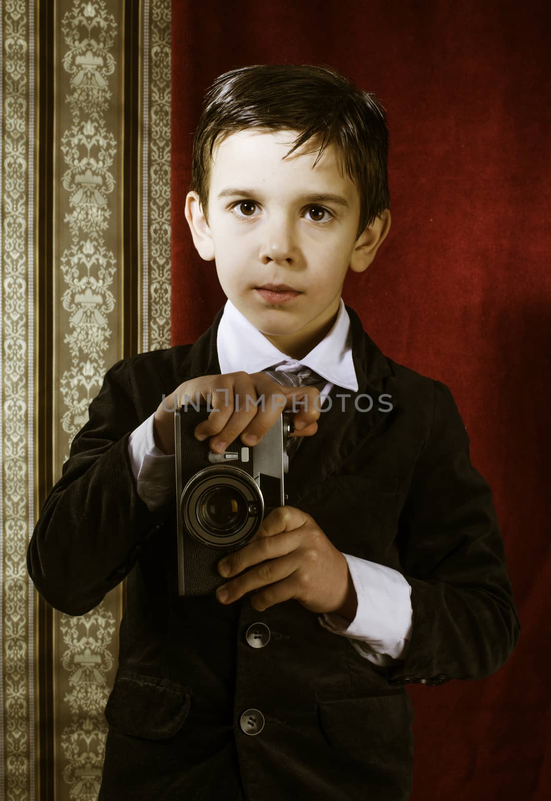 Boy with vintage camera. Vintage clothes