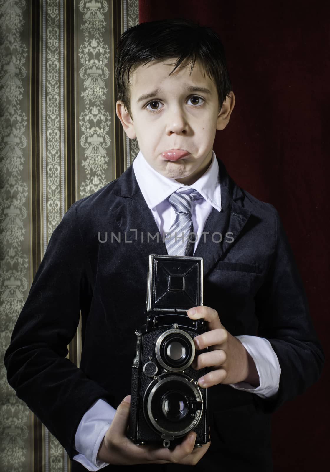 Child taking pictures with vintage camera by deyan_georgiev