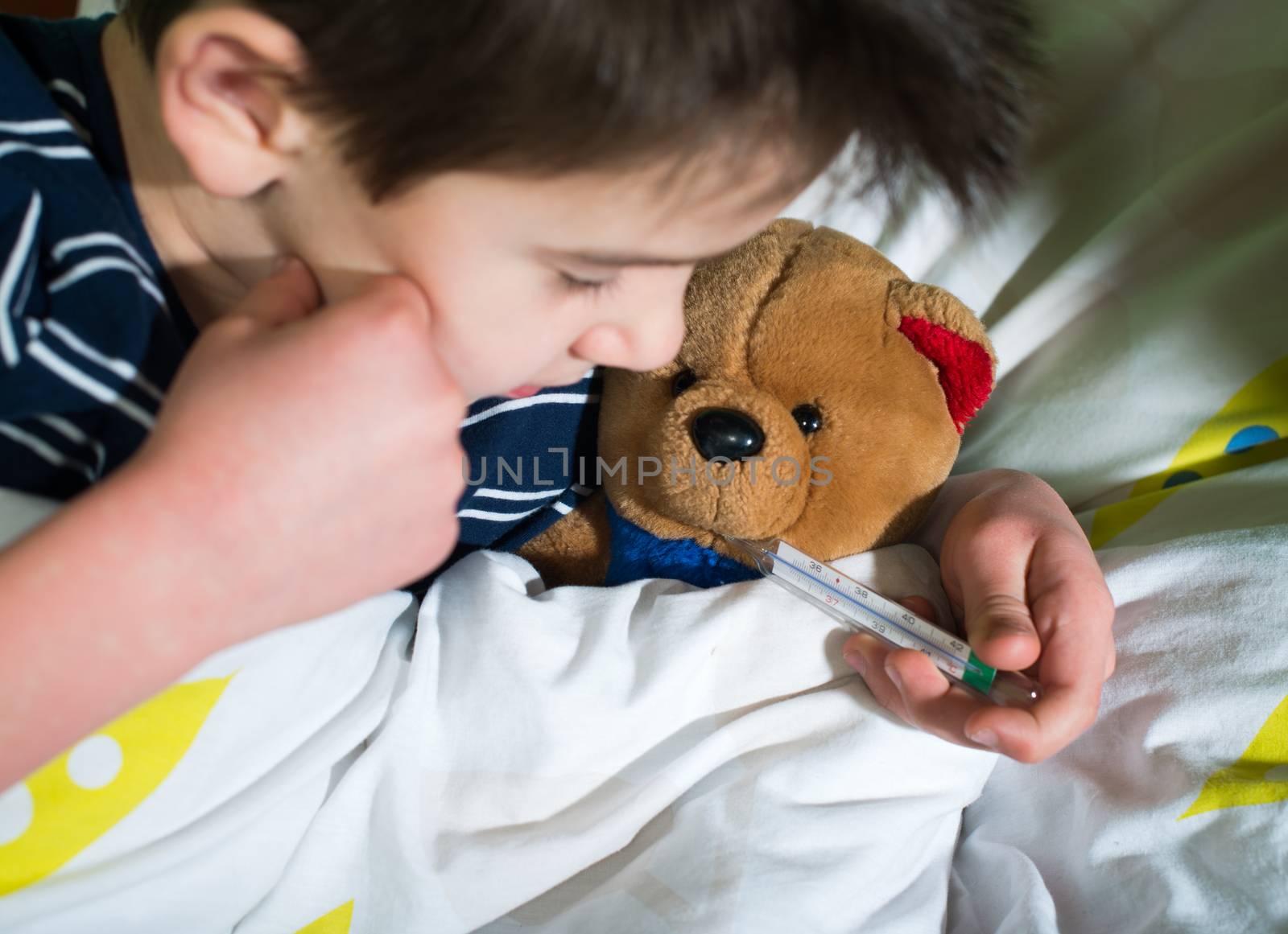 Sick child in bed with teddy bear by deyan_georgiev