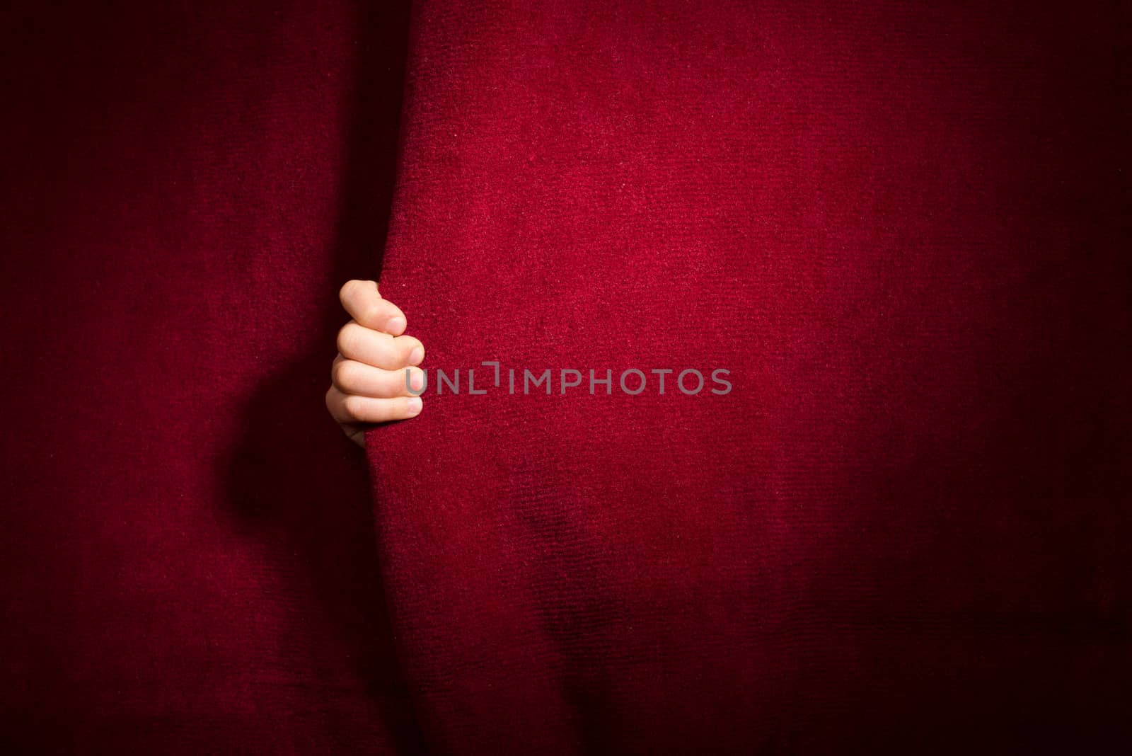 Hand appearing beneath the curtain. by deyan_georgiev