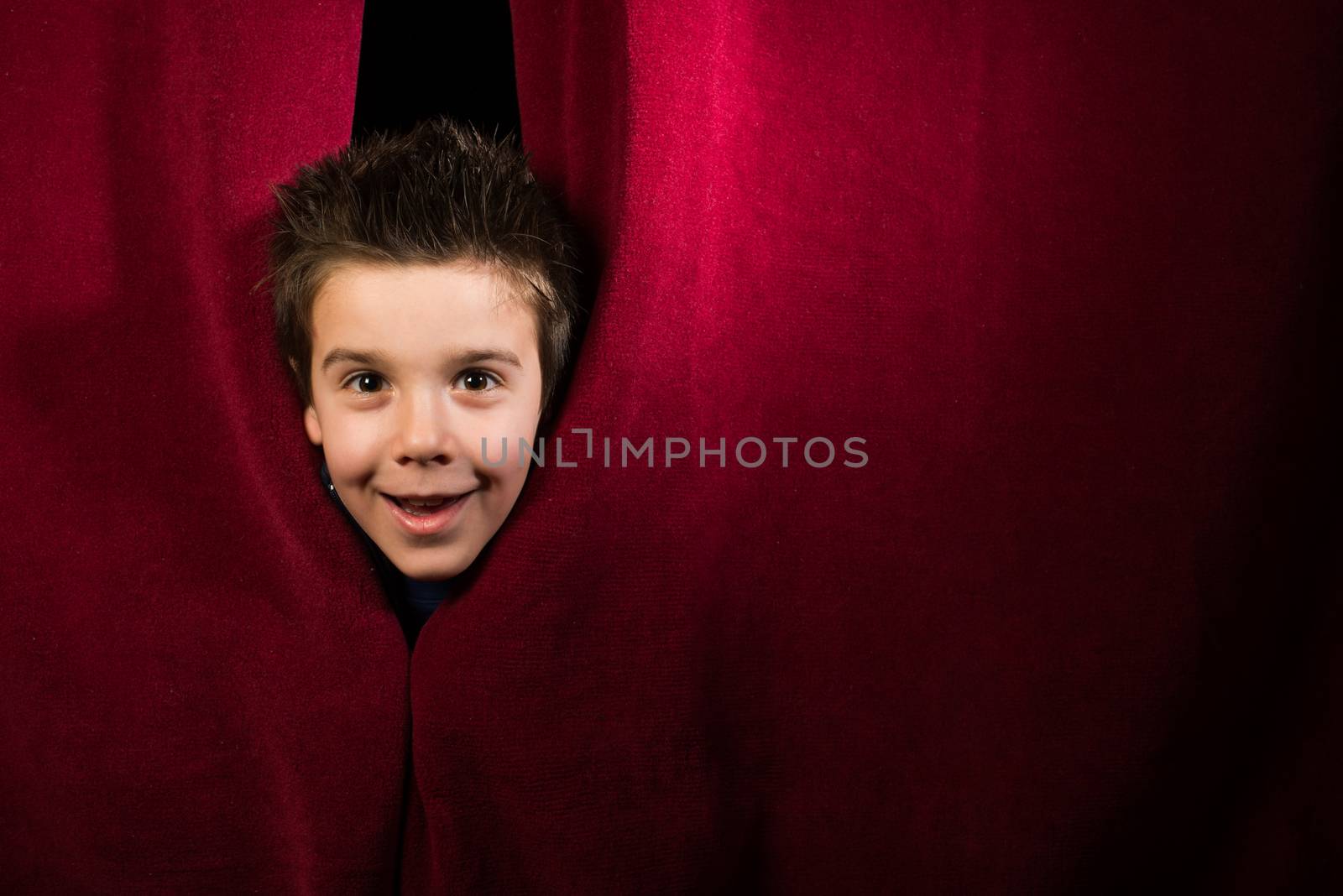 Child appearing beneath the curtain by deyan_georgiev