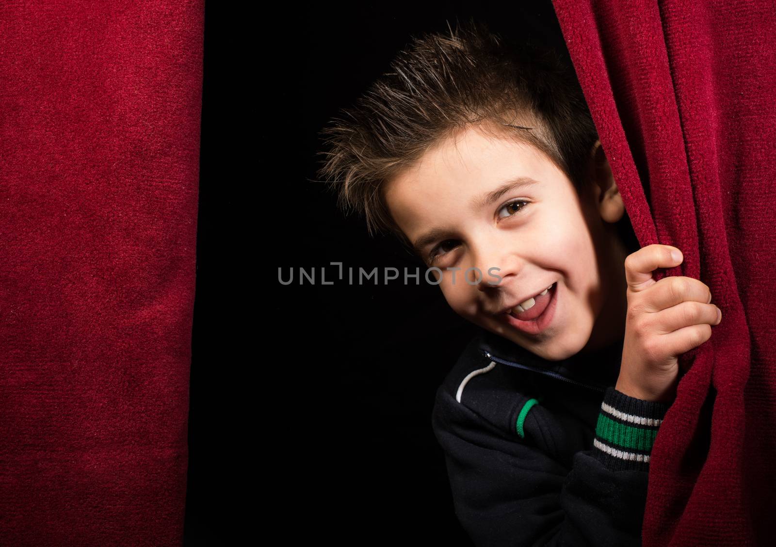 Child appearing beneath the curtain by deyan_georgiev