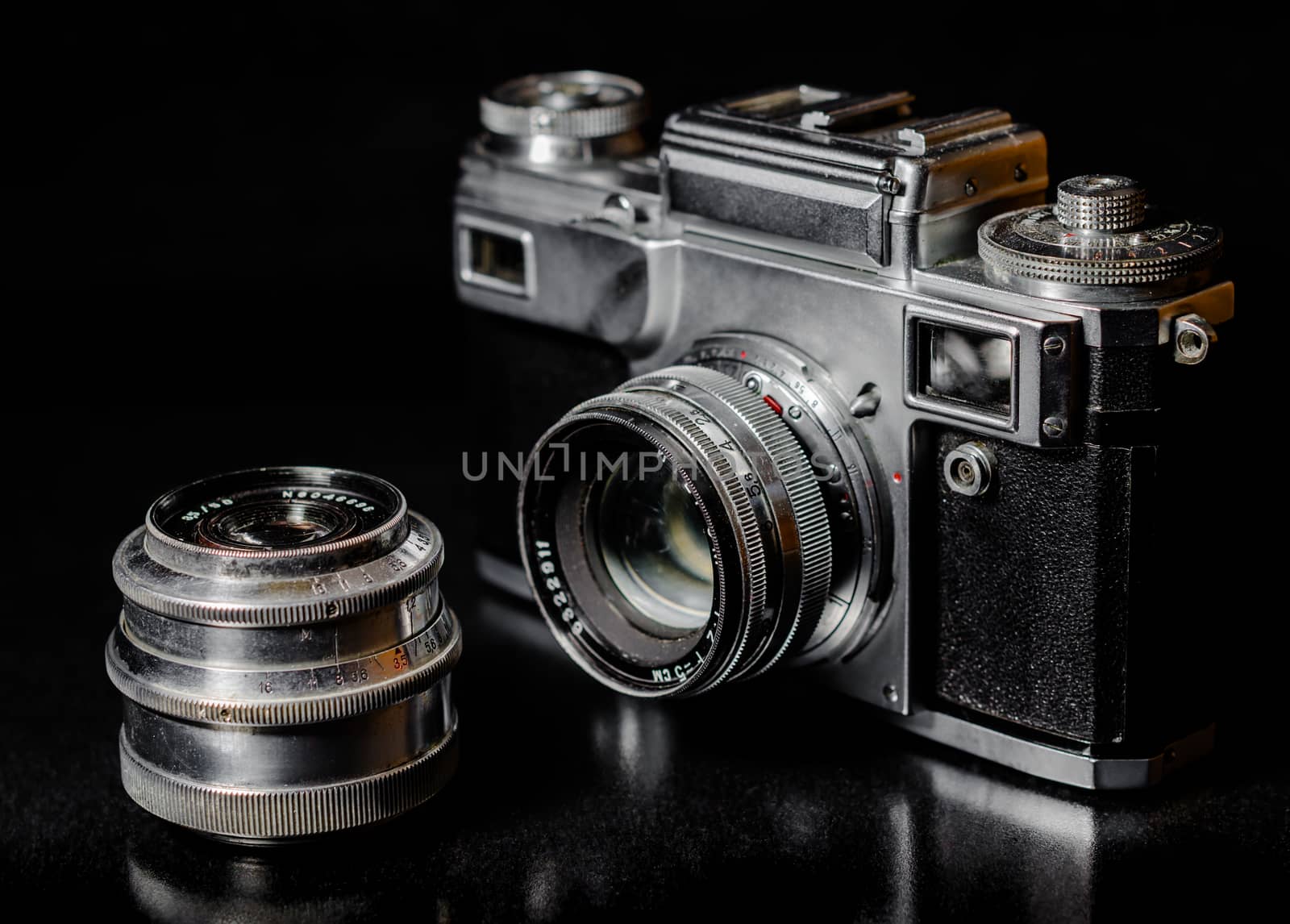 vintage camera and vintage lens on black background