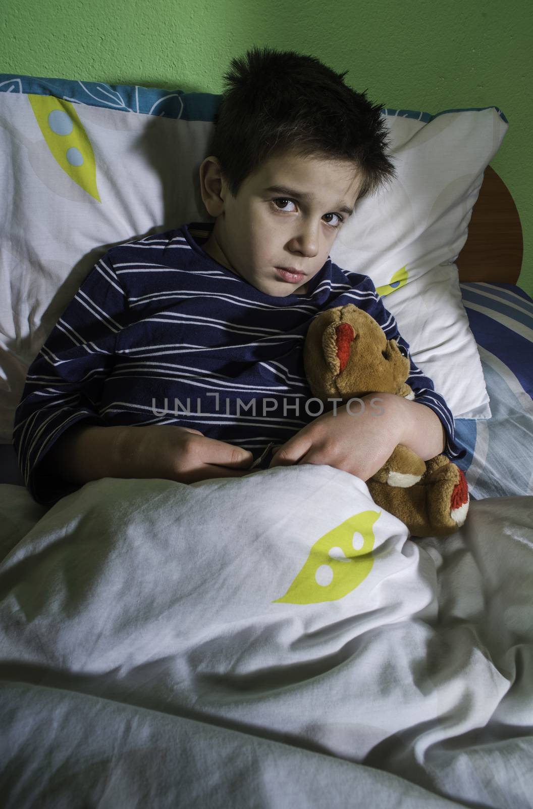 Sick child in bed with teddy bear by deyan_georgiev